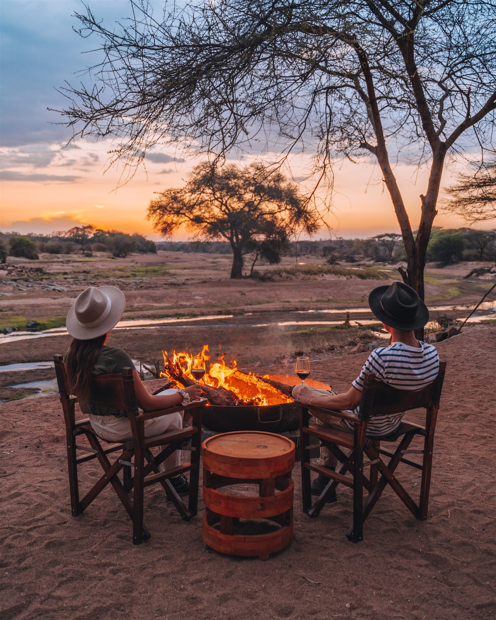Couple enjoying a private Asanja Ndembo sundowner in Ruaha National Park